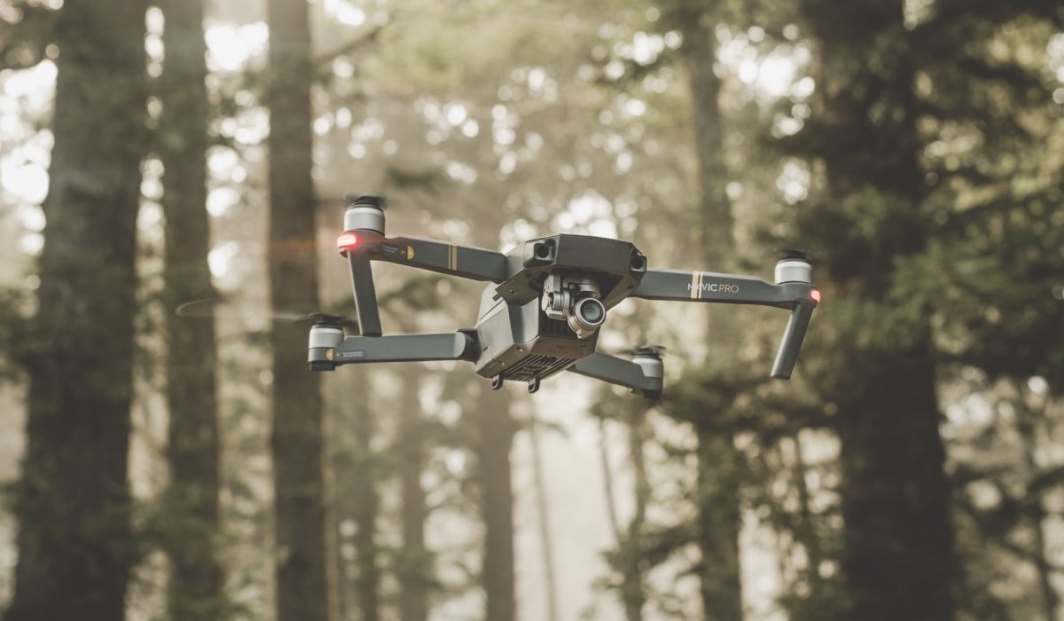 A drone flying through a forest