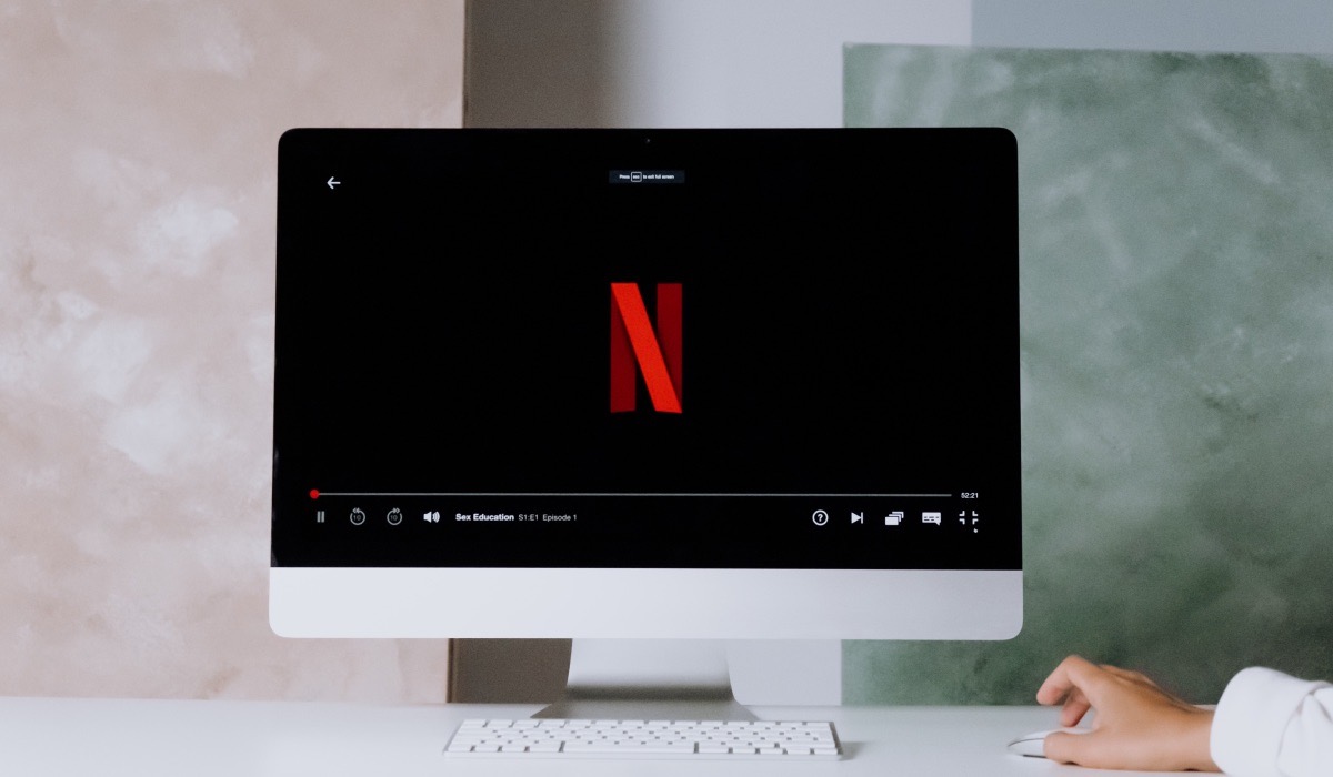 Dark Netflix logo on a Apple monitor screen in a room